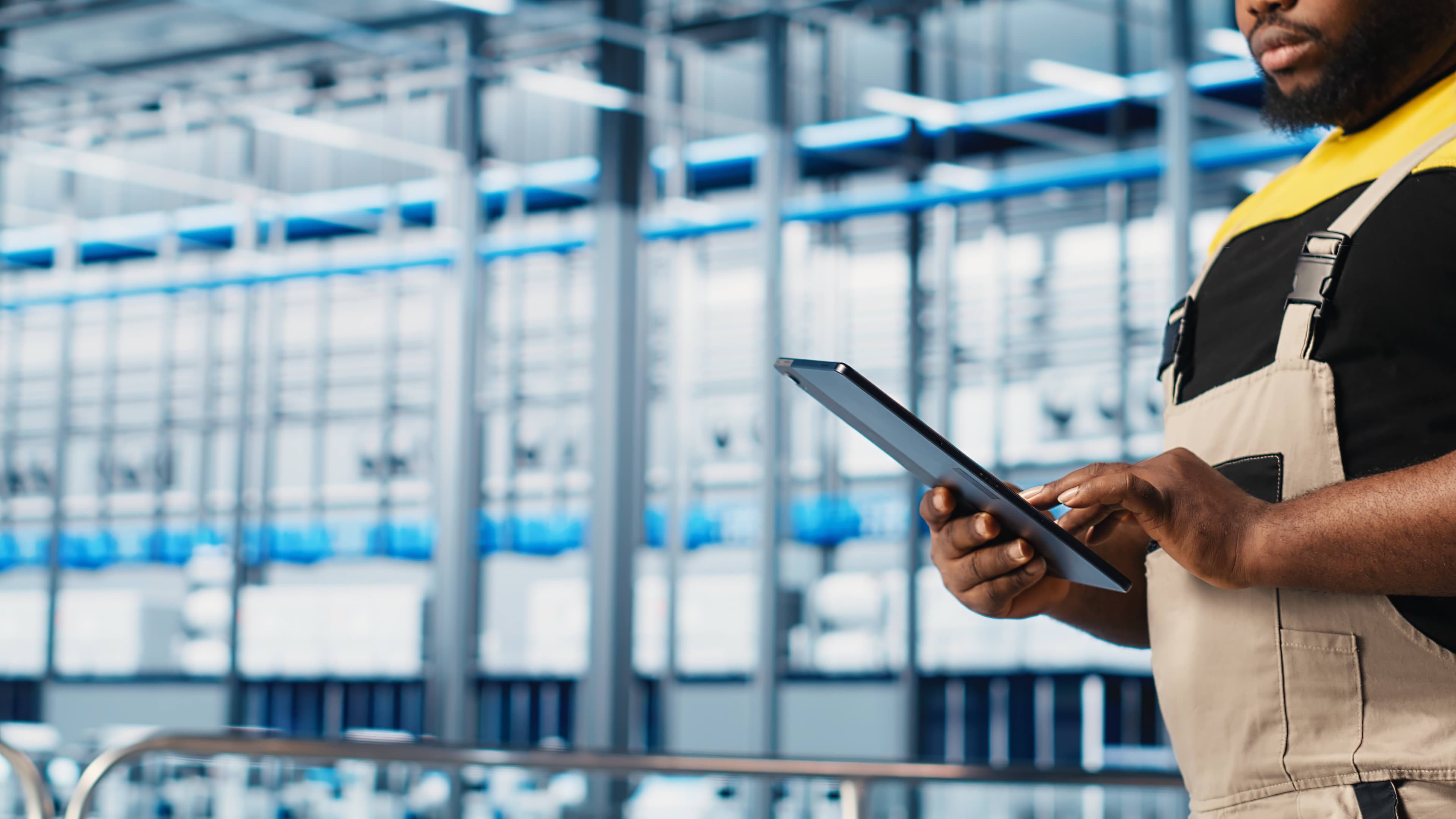 Expert using digital tablet to monitor automated poultry farm systems
